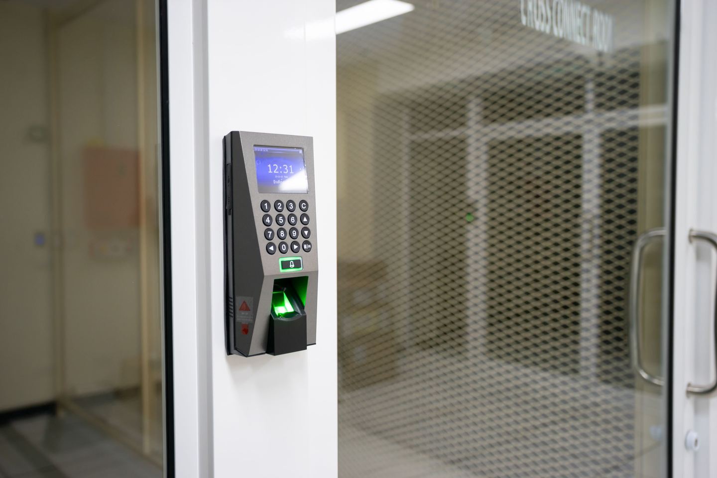 Fingerprint time attendance machine on an office door in Dubai